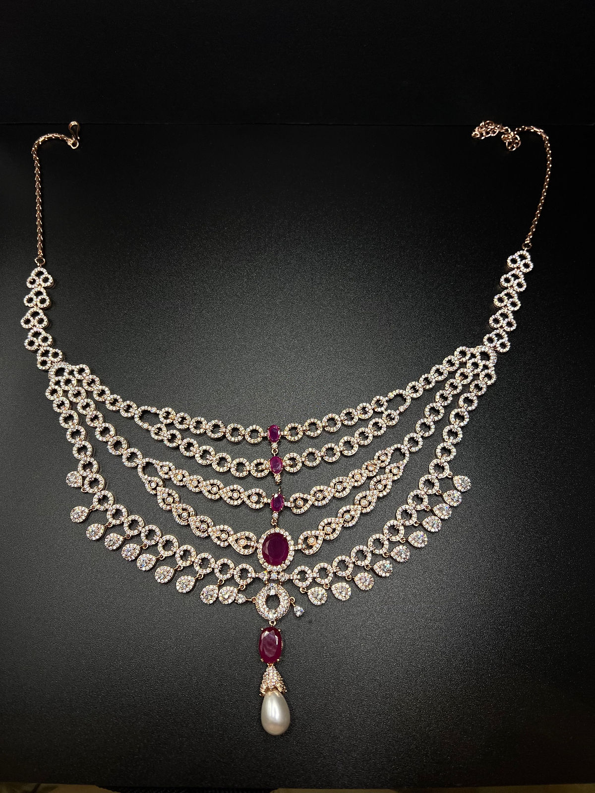 Rose gold and pink five layered necklace with dangle earrings.